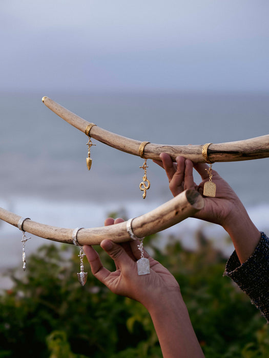 Jewelry on a branch with a blurred natural background
