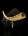 Wooden horn with silver charms on a black background