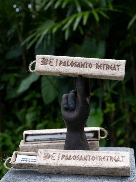 Decorative item with 'Palosanto Retreat' text on a dark background