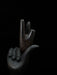 Wooden sculpture of a hand holding a smaller hand against a black background