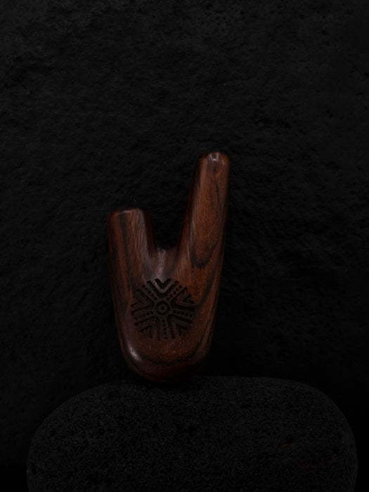 Wooden shoe tree on a dark textured background