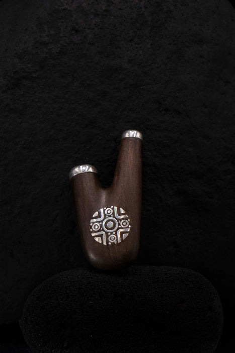 Wooden object with a decorative design on a black background