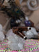 Wooden and metal pipe on a crystal base with a colorful fabric background
