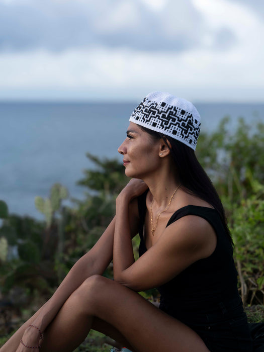 Woman sitting outdoors with a scenic background