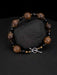 Bracelet with brown and black beads on a dark surface
