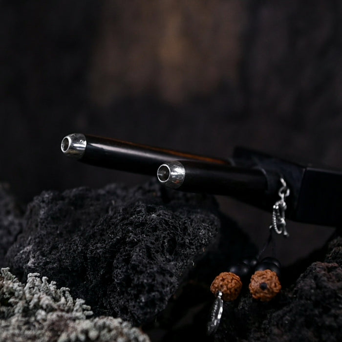 Black pen with silver accents on a textured dark surface