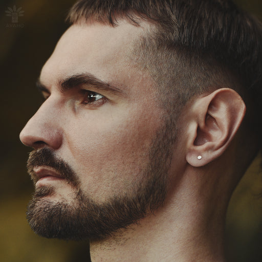 Close-up of model wearing minimalist flat disc earrings, highlighting their lightweight comfort and how they subtly catch light against bare skin