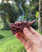 Decorative wood smoking pipe with a dragon motif, combining functionality and artistic design.