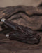 Deep wood texture of the kuripe with dragon carvings, emphasizing its natural appearance.