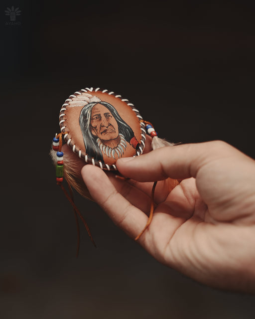 Delicate feather and bead brooch resembling a mini dreamcatcher, pinned to a lace shawl for festival-ready elegance