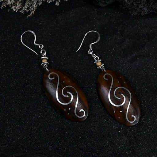 Handcrafted matching carved earrings set, embodying spiritual harmony, reflecting shamanic protection