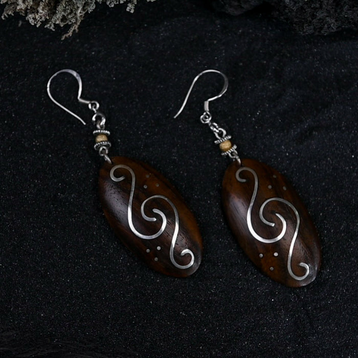 Handcrafted matching carved earrings set, embodying spiritual harmony, reflecting shamanic protection