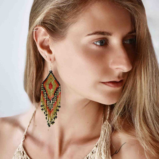 Vibrant Ikaros beaded earrings with intricate Japanese craftwork and silver fastening, blending protection symbolism with bohemian style