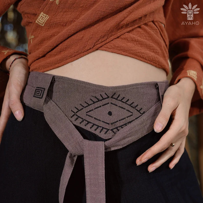 Close-up of unisex cotton pants featuring a white hand-embroidered tribal pattern, embodying Boho and shamanic styles