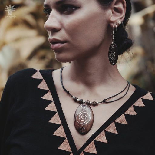 Handcrafted rosewood pendant and matching carved earrings set, embodying spiritual harmony with black kyanite and Rudraksha beads, reflecting shamanic protection