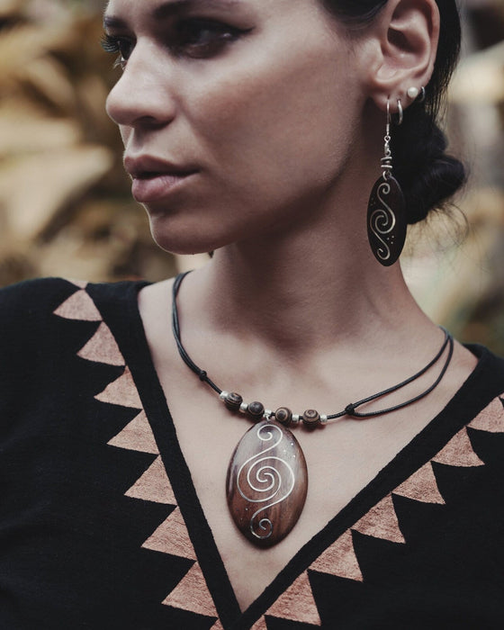Handcrafted rosewood pendant and matching carved earrings set, embodying spiritual harmony with black kyanite and Rudraksha beads, reflecting shamanic protection