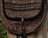 Compact ethnic shoulder bag with secure compartments for spiritual tools and personal items