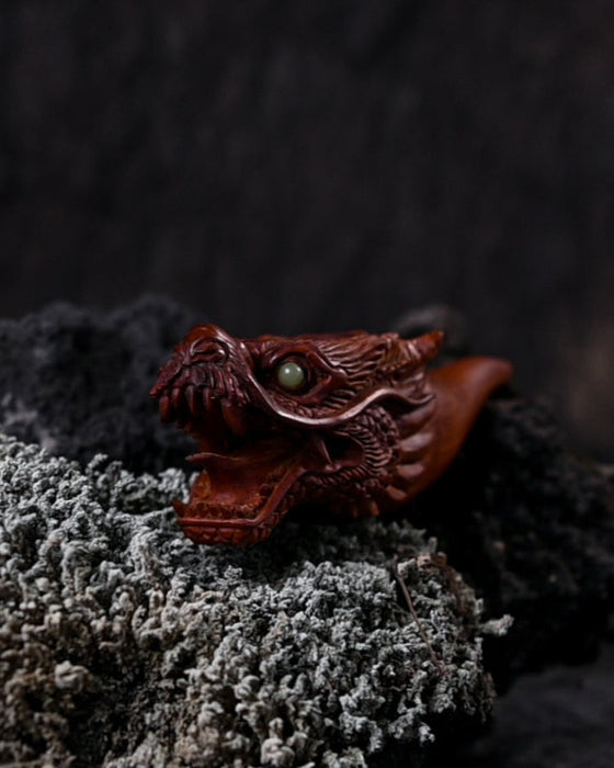 Handcrafted wood smoking pipe featuring a detailed dragon, a true masterpiece for any smoker.