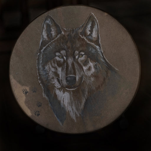 A cultural treasure, this handcrafted shaman drum featuring a striking wolf design reflects traditional artistry and significance.