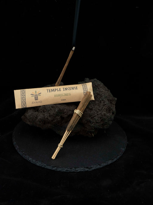 Incense stick and packaging on a dark surface