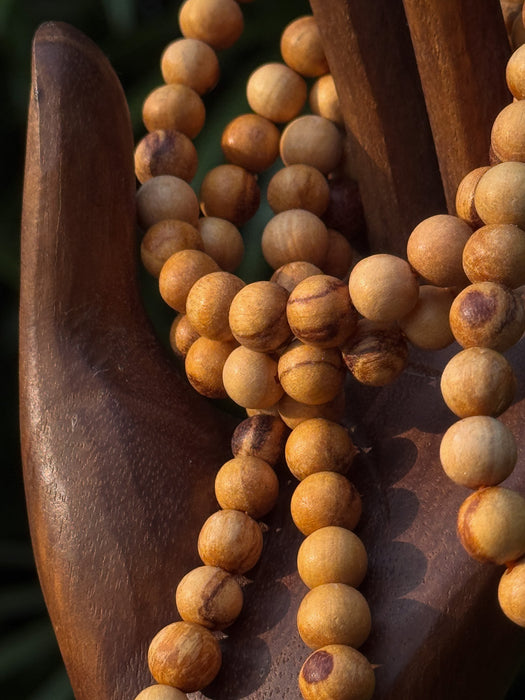 Wooden beaded necklace on a wooden surface