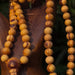 Close-up of a wooden beaded necklace on a dark background