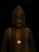 Statue of a figure with a dark background