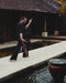 Person practicing yoga by a poolside with traditional architecture in the background