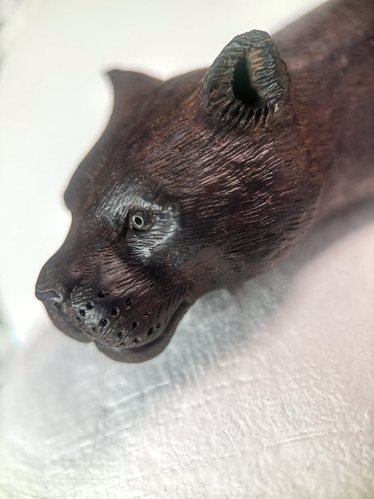 Wooden bear figurine on a light background