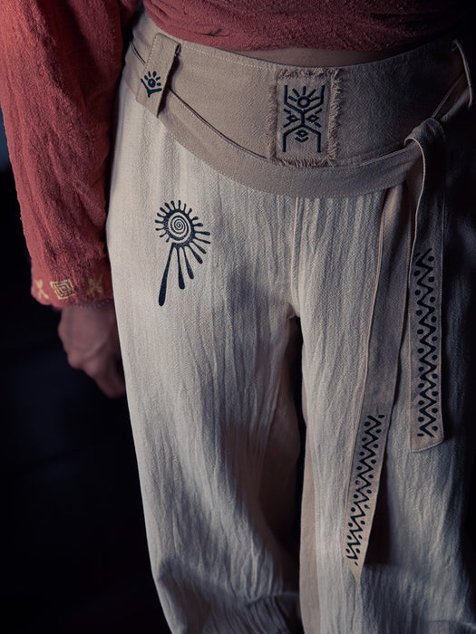 Light-colored pants with black patterns on a dark background