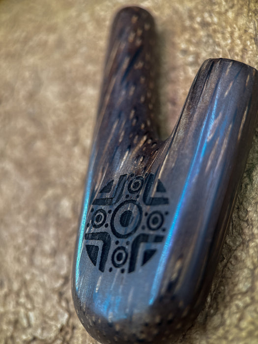 Metallic object with a logo on a textured surface