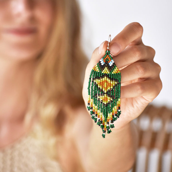 Vibrant Ikaros beaded earrings with intricate Japanese craftwork and silver fastening, blending protection symbolism with bohemian style