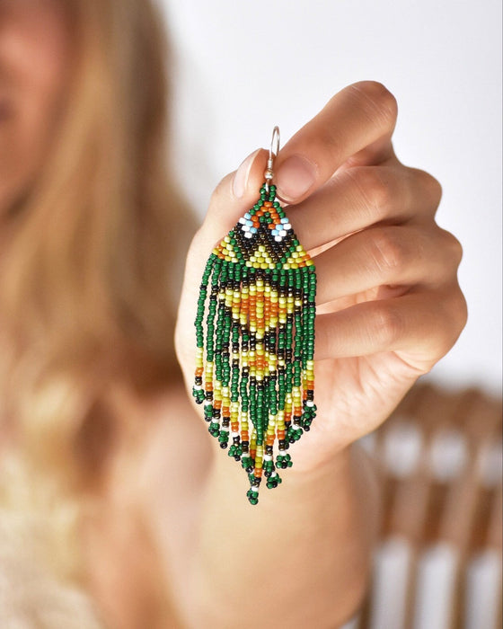 Vibrant Ikaros beaded earrings with intricate Japanese craftwork and silver fastening, blending protection symbolism with bohemian style
