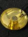 Gold pendant with a black cord on a dark background