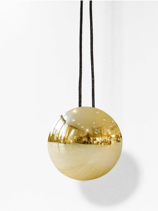 Gold spherical pendant light on a white background