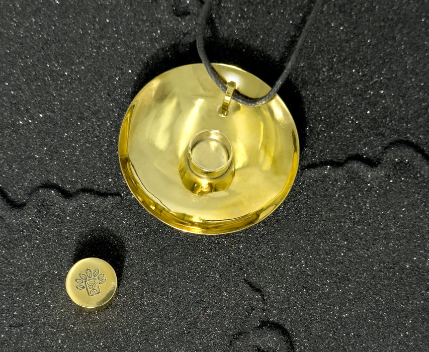 Gold pendant on a black background