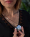 Person holding a silver sequin ball with a blurred background