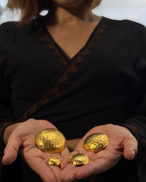 Person holding gold coins in their hands