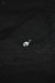 Silver pendant on a dark textured fabric background
