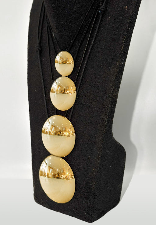 Black boot with gold spherical decorations on a white background