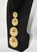 Black boot with gold spherical decorations on a white background