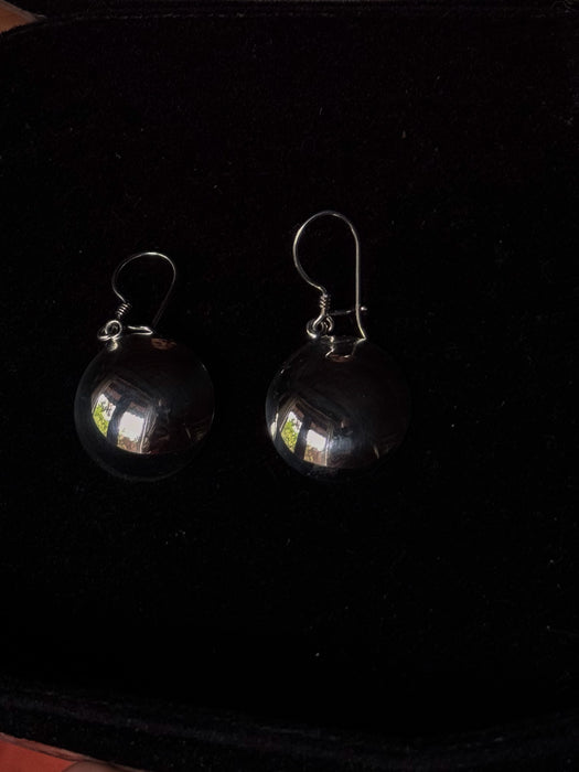 Pair of earrings on a dark background