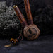 A hand presents a wooden kuripe pipe, meticulously handcrafted for hape snuff application This unique smoking accessory, with its necklace design and rustic charm, exemplifies traditional shamanic tools and doubles as a protective herbal medicine kit