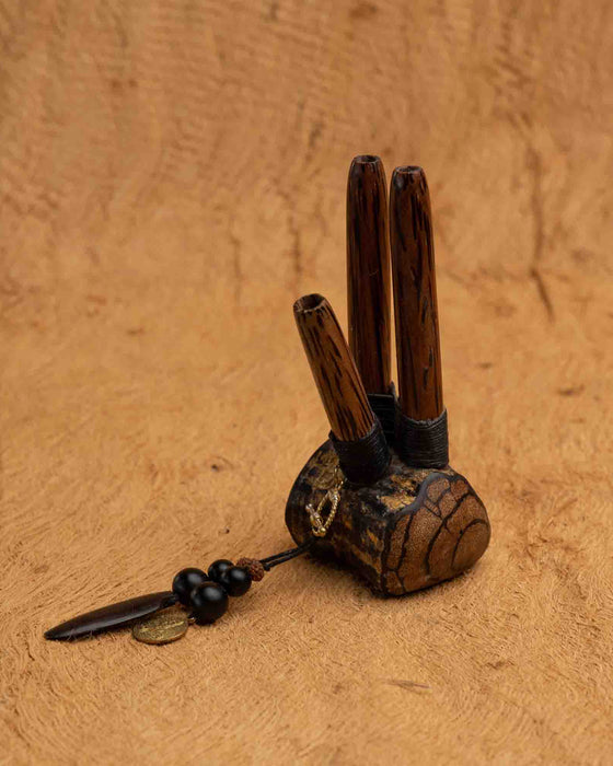 Close-up of a man using a Handmade Double Hape Kuripe, a shamanic ceremony tool for Rapé snuff application, showcasing the pipe&#39;s intricate sacred geometry and totem design for spiritual healing, meditation, and protection