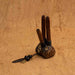 Close-up of a man using a Handmade Double Hape Kuripe, a shamanic ceremony tool for Rapé snuff application, showcasing the pipe&#39;s intricate sacred geometry and totem design for spiritual healing, meditation, and protection