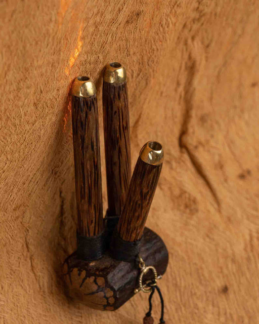 Wooden wall hook with gold accents on a wooden background
