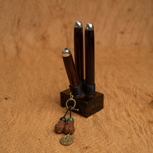 Crafted from rosewood and silver with a green ruby, this Double Shot Kuripe is a handmade shamanic snuff pipe, perfect for hape spiritual healing ceremonies. A unique, sacred geometry-inspired gift offering protection and meditation.