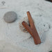 Two wooden sticks on a sandy surface with 'AYAHQ' branding.
