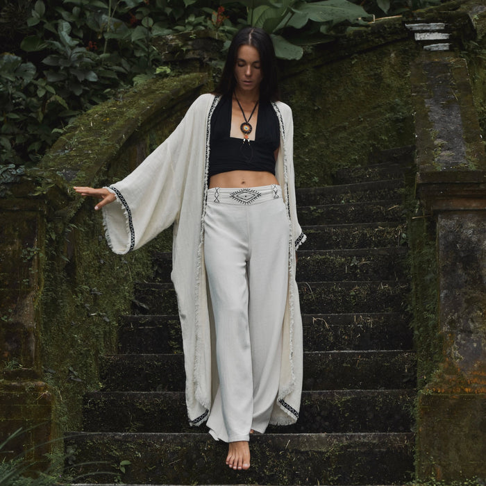 Detail of unisex boho organic cotton pants featuring a distinctive sacred geometry pattern on the belt, handcrafted for a blend of style and comfort in bohemian fashion. White