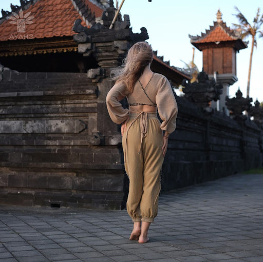 Close-up of cotton pants featuring a white hand-embroidered tribal pattern, embodying Boho and shamanic styles